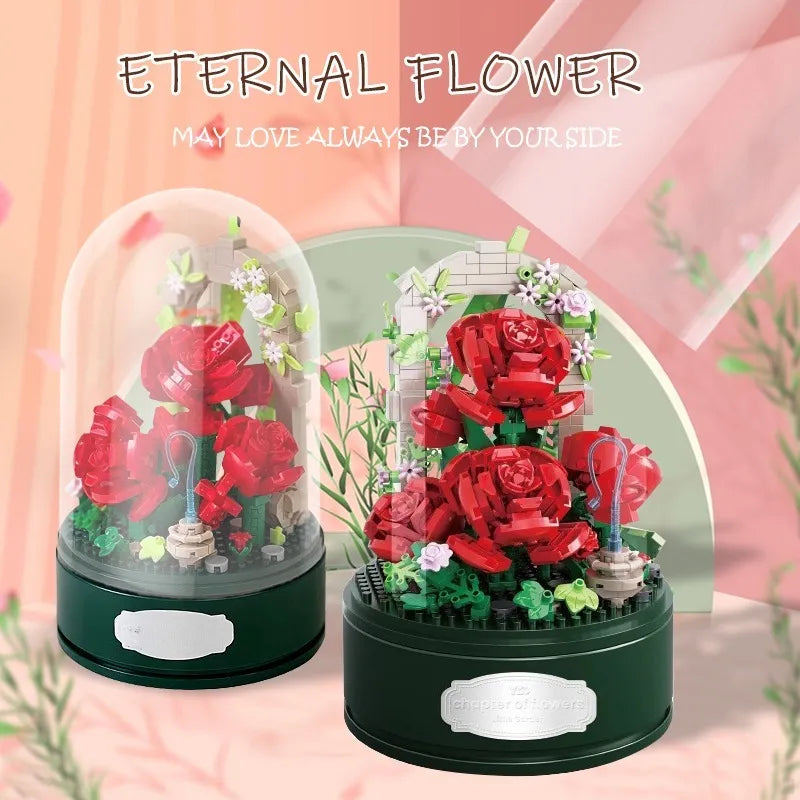Two views of the rose music box, with and without the clear dome, on a soft pink background