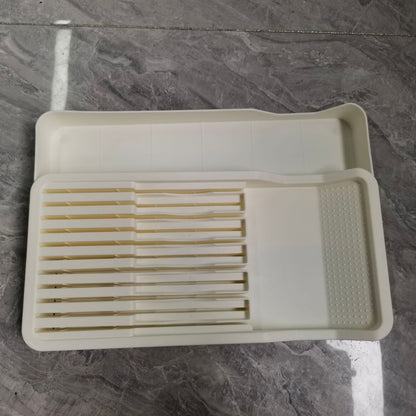 White knife and cutlery drawer organizer on a countertop