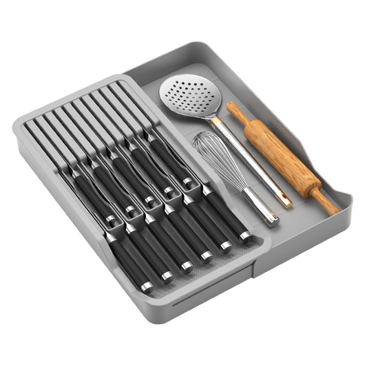 Gray knife and cutlery drawer organizer holding knives, a whisk and a rolling pin