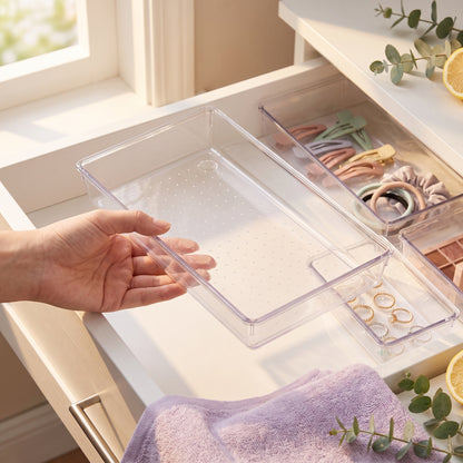 Hand lifting a clear tray to show its dotted non-slip base