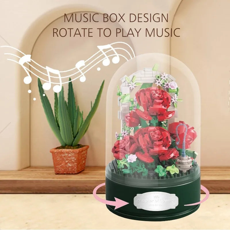 Rose Garden Music Box under its clear dome on a wooden shelf, arrows showing the base rotating