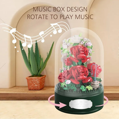 Rose Garden Music Box under its clear dome on a wooden shelf, arrows showing the base rotating