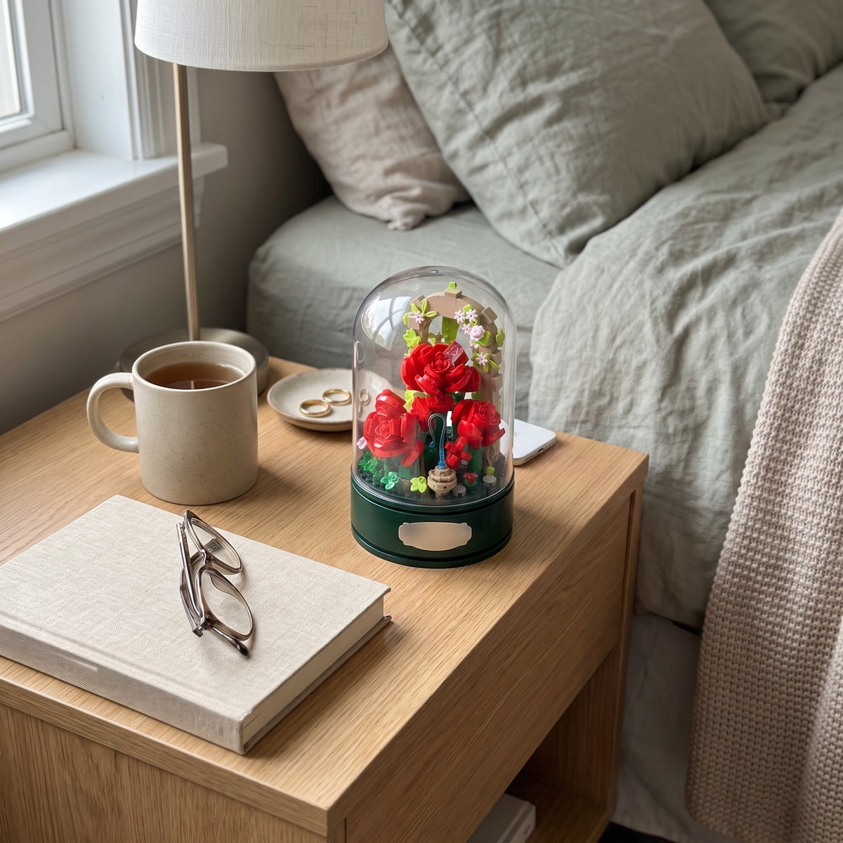 Rose Garden Music Box under its clear dome on a bedroom shelf, seen from above at an angle