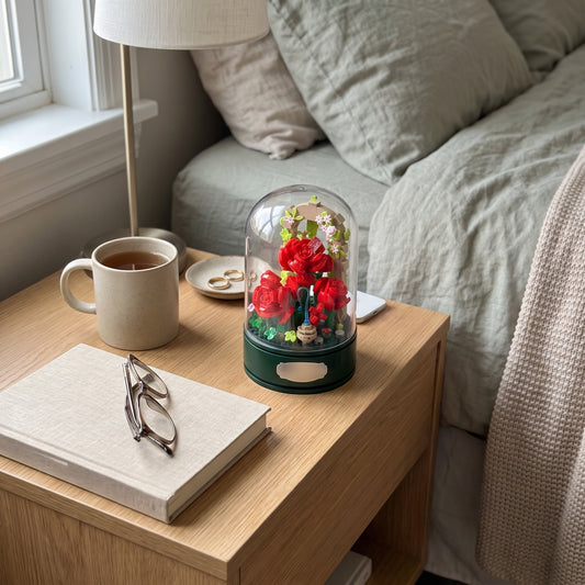 Rose Garden Music Box under its clear dome on a bedroom shelf, seen from above at an angle