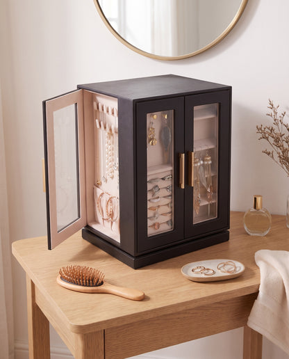 A tidy dressing table with the jewelry cabinet holding every necklace, ring and earring
